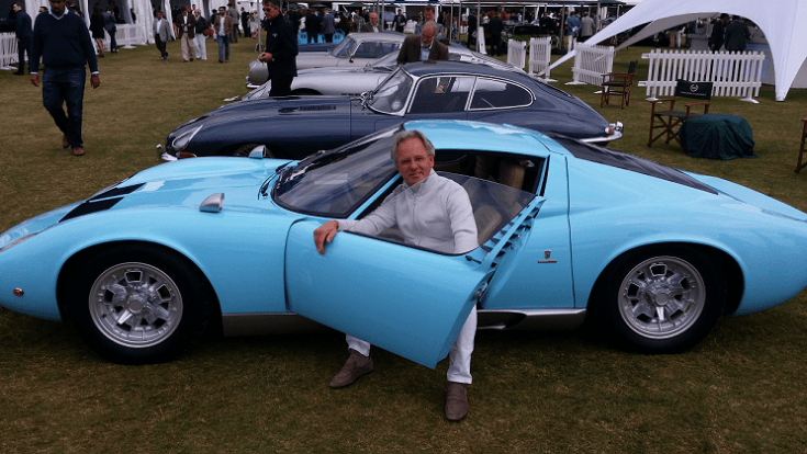 Horacio Pagani sitting in a light blue Lamborghini Miura P400