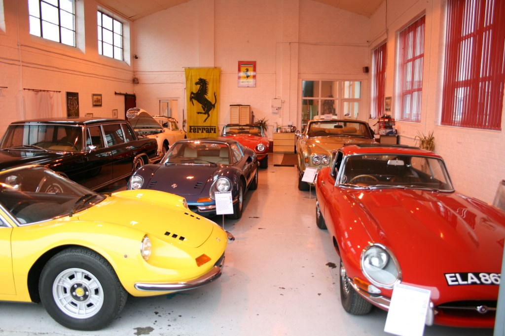 View of Iain Tyrrell's workshop which features several classic cars.